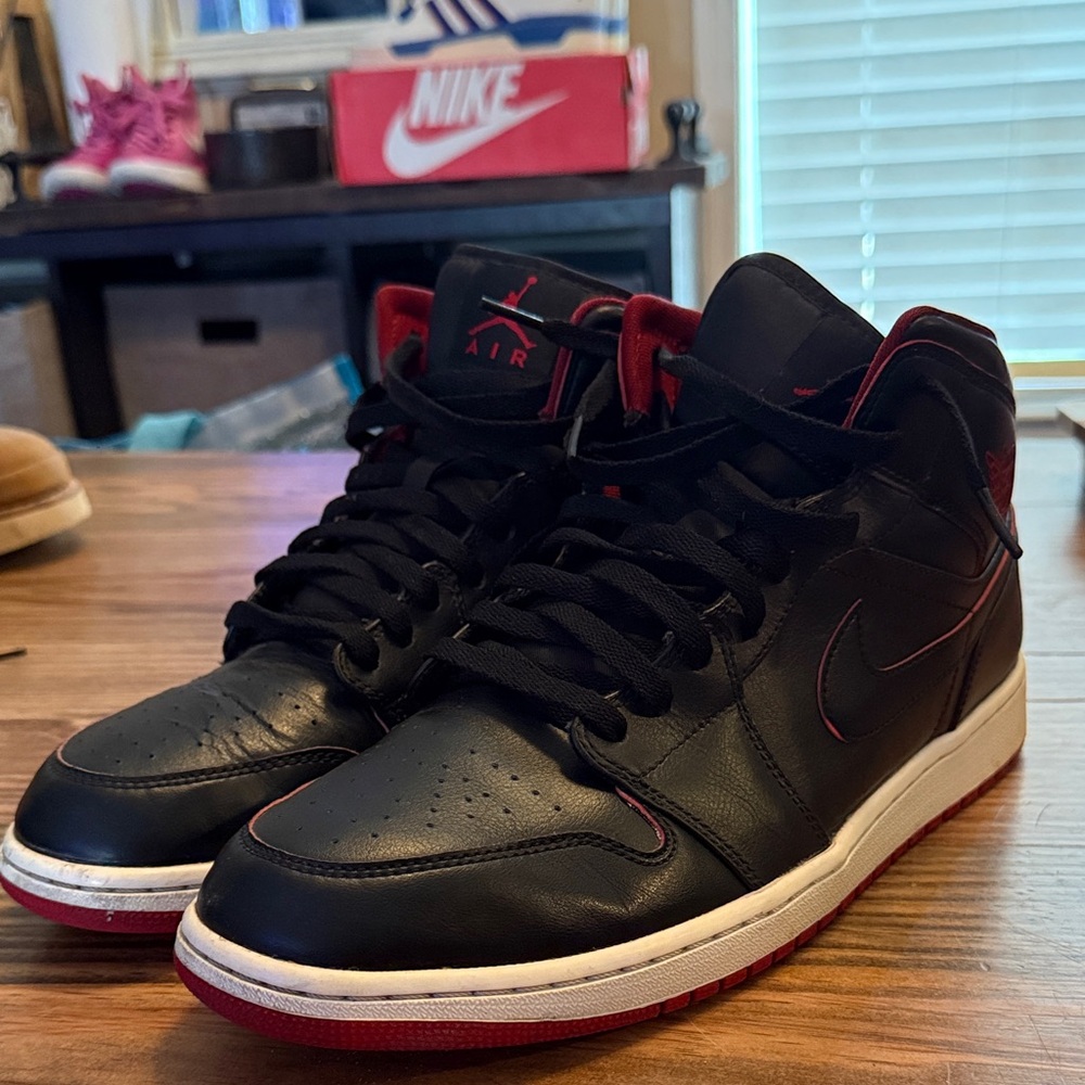 Nike Jordan 1 mid black and red color way.